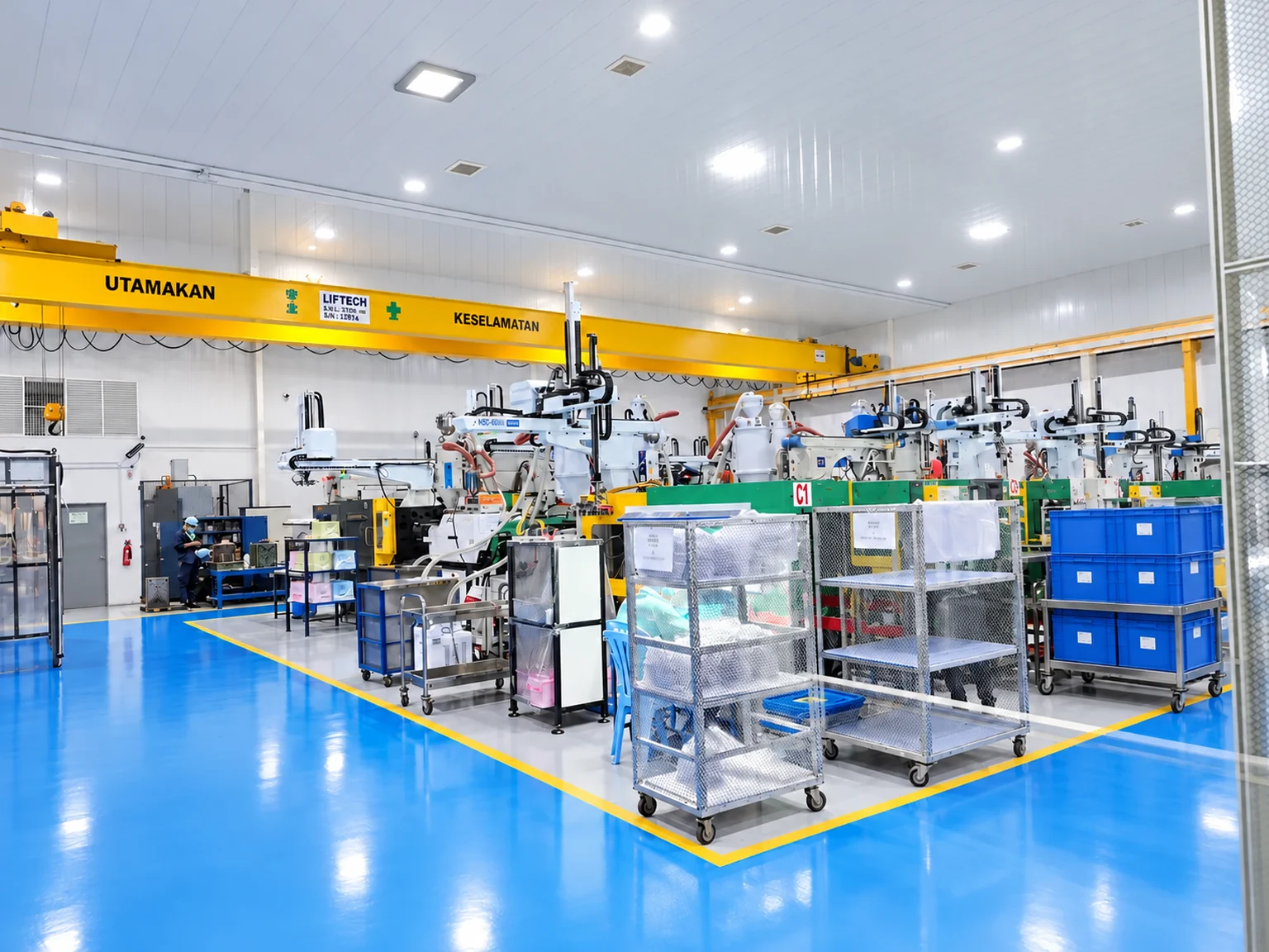 Nagoya production floor with injection moulding equipment and material trolleys